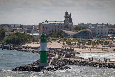 Green-white lighthouse, pier light Westmole, hotels in the background, Warnemünde, Rostock,