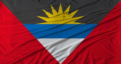 Antiguan flag waving. Flag of Antigua and Barbuda with cloth texture