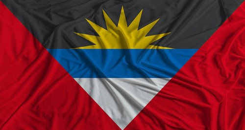 Antiguan flag with fabric texture background. National flag of Antigua and Barbuda
