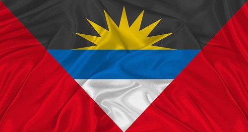 Antigua and Barbuda flag with cloth texture. Close up of Antigua and Barbuda flag waving