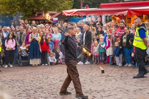A fire juggler impresses the audience with his tricks on a busy square, Feuernacht, Sindelfingen,