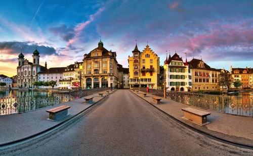 View of Lucerne's old town with Jesuit church from the Reuss bridge at dawn, Canton of Lucerne,