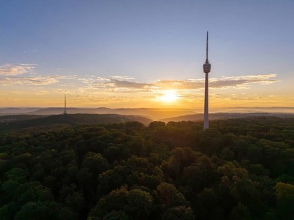 Hilly wooded landscape with television tower at sunrise in the background, Stuttgart-Degerloch,