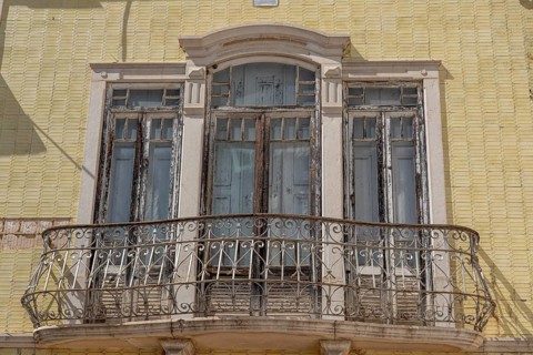 Facade of buildings decorated with tiles, azulejos, coloured tiles on facades, in Tavira, old town,
