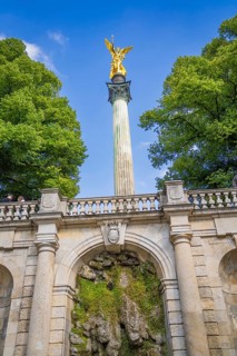 A magnificent golden statue on a column above a staircase, Munich, Germany