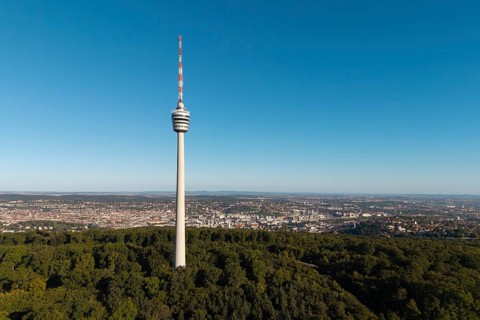 Television tower rises above a wooded area against an urban backdrop, Stuttgart, Baden-Württemberg,