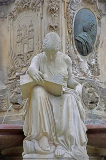 Seated white female figure reading a thick book as a symbol of science, allegory, knowledge,