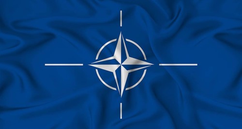 Realistic NATO flag waving. Close up of flag of NATO with cloth texture