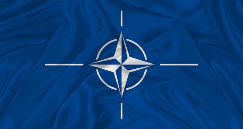 Flag of NATO with cloth texture. Close up of NATO flag waving