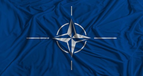 NATO flag with fabric texture background. National flag of NATO with cloth texture