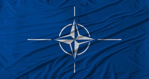 NATO flag waving. Flag of NATO with cloth texture