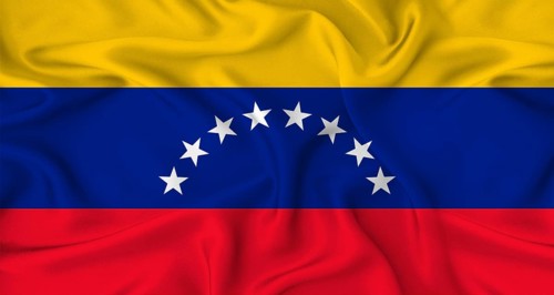 Realistic Venezuela flag waving. Close up of flag of Venezuela with cloth texture