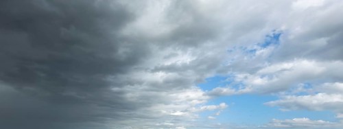 Panorama photo from left cold front clouds of cumulus clouds right in front altocumulus clouds and