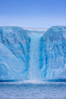 Waterfall at edge of the Brasvellbreen glacier from the ice cap Austfonna debouching into the