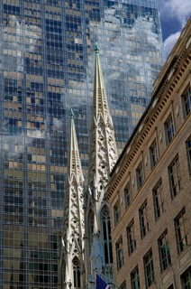 Towers of St Patrick's Cathedral in front of the facade of a skyscraper, Manhattan, New York City,