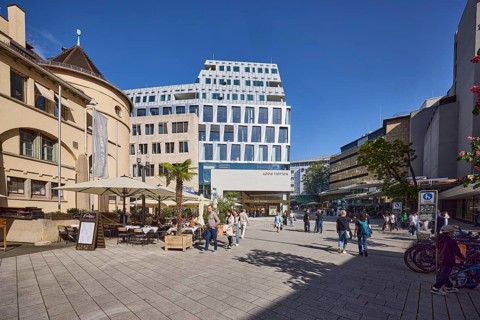Market hall, historical building, shopping, outdoor area with tables, chairs and parasols,