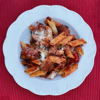 Classic Italian Sardinian vegetarian pasta dish with paste Penne rigate Melanzane aubergine passata