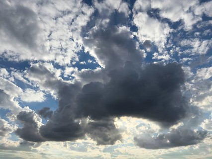 In the centre of the picture large dark cloud Cumulonimbus cloud Thunderclouds announce rain above