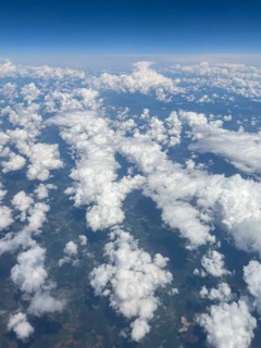 Aerial view from aeroplane at high altitude of white, bright cluster clouds Altocumulus,