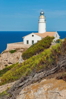 Lighthouse on Capdepera cliff on the east coast of the Mediterranean island of Majorca, blue sea in