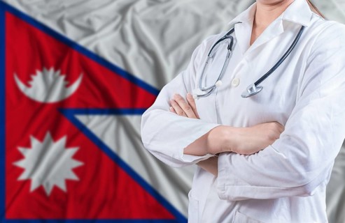 Doctor with crossed arms on Nepal flag. Nepali health and care concept. Female doctor on Nepal flag