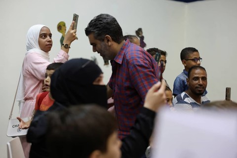 A Syrian puppeteer entertains children at the Damascus International Fair by imitating the role of