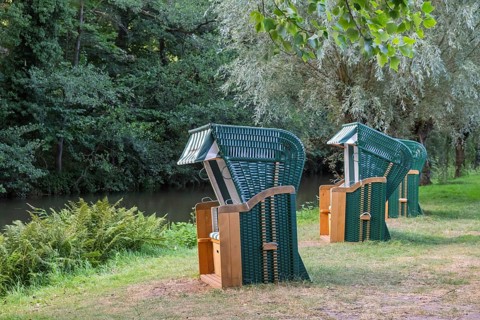 Three green beach chairs by a river, Ahaus-Alstätte, Münsterland, North Rhine-Westphalia, Germany