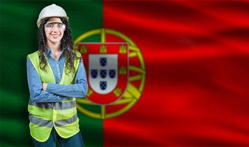 Portrait of smiling female engineer with Portuguese flag in background. Young female construction