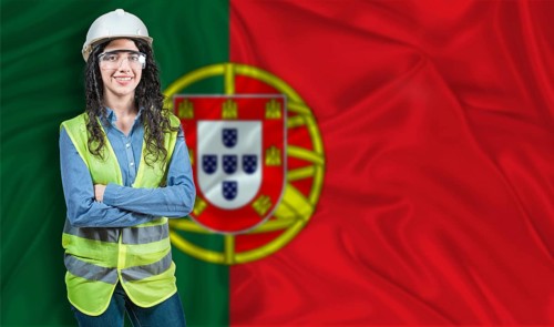 Young female construction engineer with Portugal flag. Portrait of smiling female engineer with