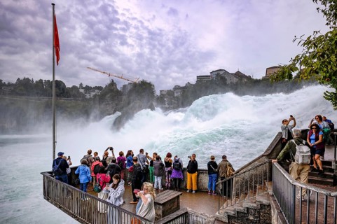 Visitors, tourists, taking selfies with smartphone, viewing platform Känzeli, Rhine Falls