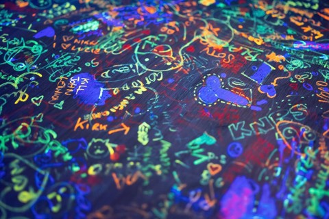 Colourful neon scribbles and graffiti on table top, arcade, Soho, London, England, Great Britain