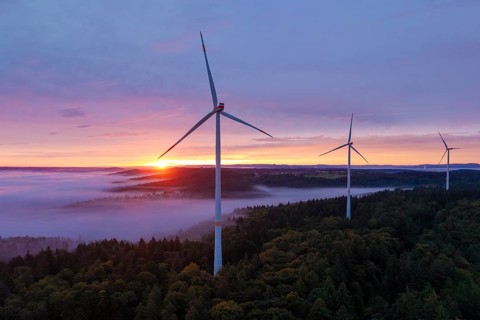Wind turbines on a hill with sunlight breaking through the fog, sunrise, near Schorndorf, Remstal,