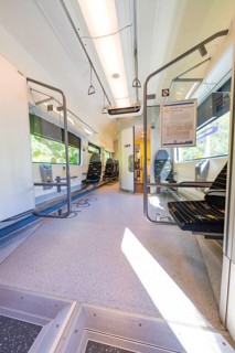 Large, bright interior of a train with wide windows, battery Electric train with green electricity,