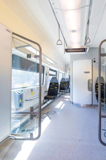 Modern and bright train interior with empty seats and lighting, battery Electric train with green