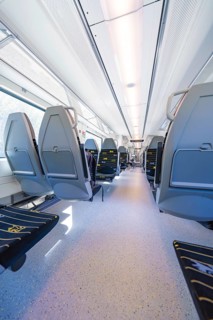 Spacious and bright train interior with modern seating arrangements, battery Electric train with