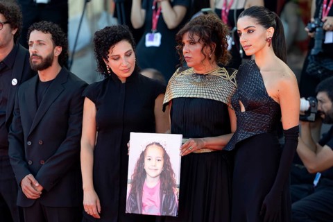 Venice, Italy - 3 September 2025: Kaouther Ben Hania (2vR) and Saja Kilani (R) with a portrait of