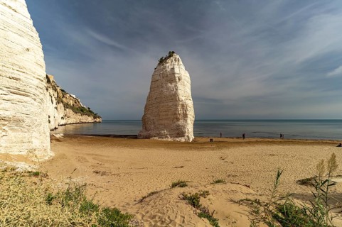 Pizzomunno rock on the Spiaggia di Castello beach in Vieste, Gargano, Apulia, Italy
