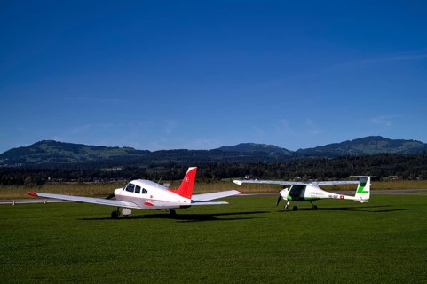 Pipistrel Velis Club on the right with aircraft registration HB-NPP stands next to Piper Archer II