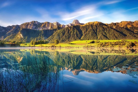 Stockhorn mountain reflected in the Uebeschi lake in the morning light, Gürbetal, Canton Bern,