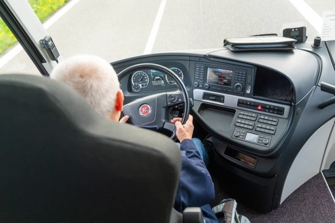 A driver steers a vehicle on the motorway, view of the steering wheel, Lake Constance, Germany