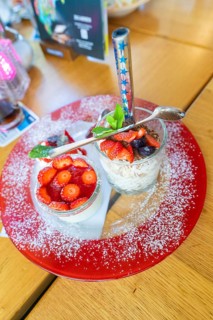 A dessert with fresh strawberries on a red plate in a restaurant, Lake Constance, Germany