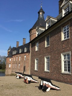 View of small cannons in front of right part of outer bailey building, left in background part of