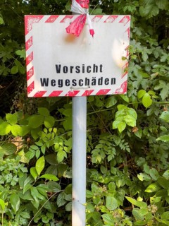Warning sign indicating road damage, Essen, North Rhine-Westphalia, Germany