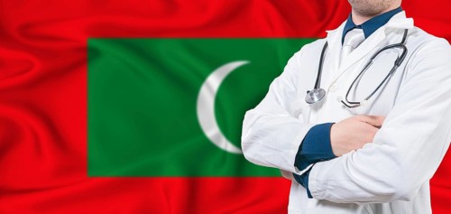 Maldives healthcare concept. Male doctor on Maldives flag. Doctor with crossed arms on Maldives
