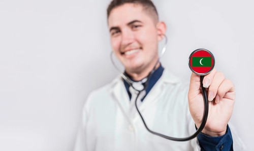 Doctor showing stethoscope with Maldives flag. Maldives national healthcare concept