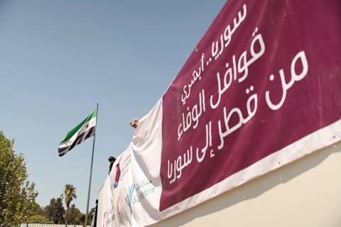 Relief workers unload boxes of medical aid provided by Qatar at Damascus International Airport,