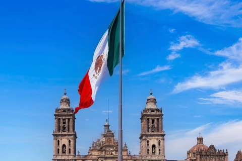 Mexican flag in Zocalo Constitution Square. Mexico city, Metropolitan Cathedral and National Palace