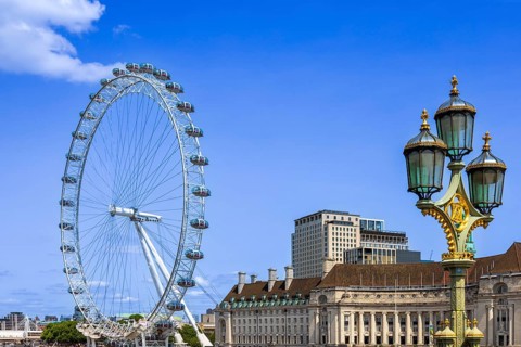 Travel attraction of London Eye Millenium ferris wheel overlooking London Big Ben and British