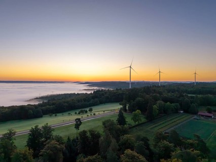 Expansive landscape with wind turbines and a veil of mist at dawn, near Schorndorf, Rems-Murr
