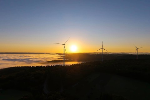 Wind turbines above a misty landscape at sunrise, near Schorndorf, Rems-Murr district,